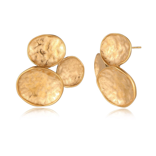Three hammered gold discs clustered together forming organic statement earrings with textured surfaces