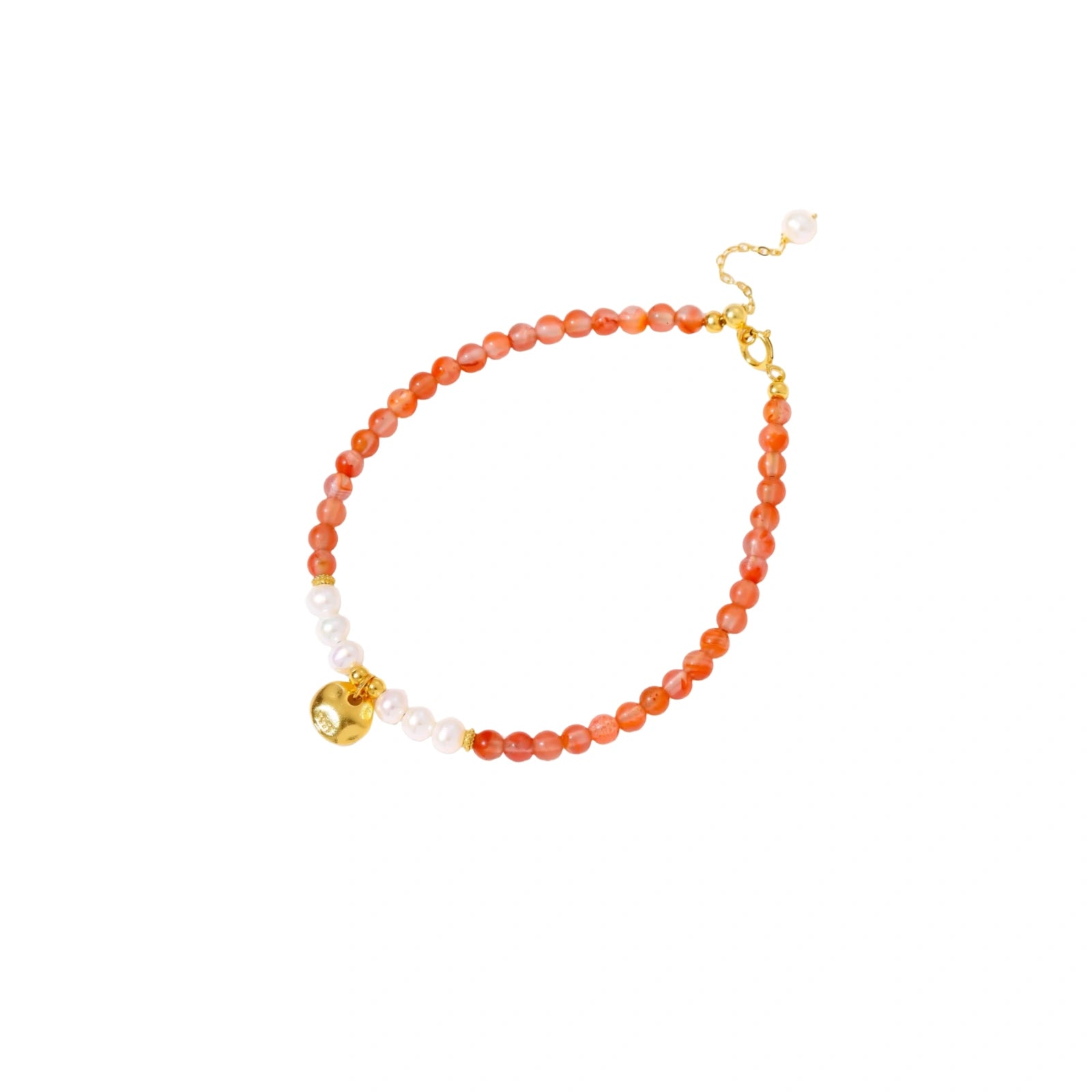 Beaded bracelet with coral-orange carnelian stones, white pearls, and gold heart charm on cream background