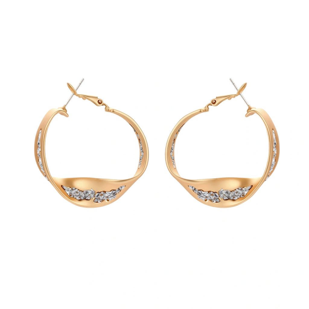 Sculptural wavy hoop earrings with crystal details and organic curved silhouette in gold and silver variants