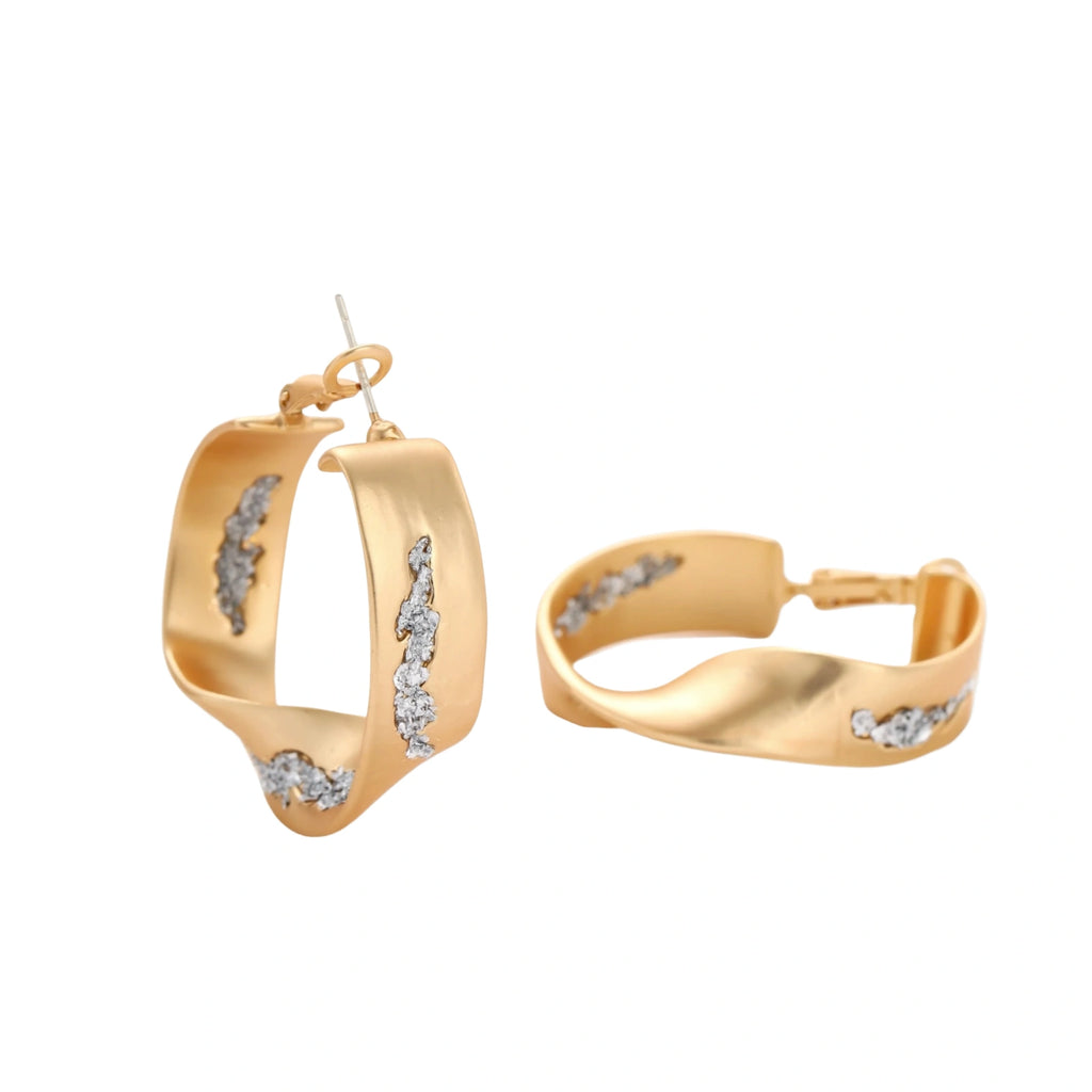 Sculptural wavy hoop earrings with crystal details and organic curved silhouette in gold and silver variants