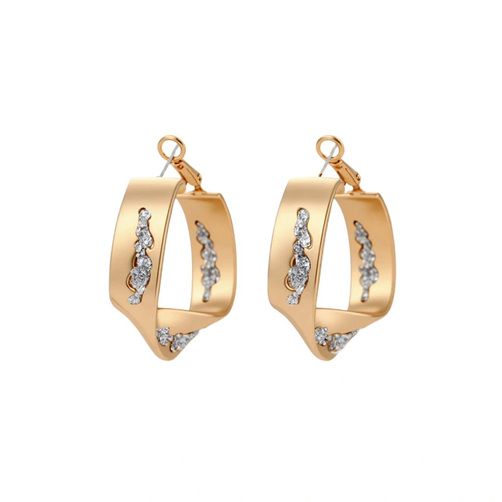 Sculptural wavy hoop earrings with crystal details and organic curved silhouette in gold and silver variants