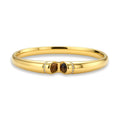 Polished gold bangle with two oval tiger's eye cabochons flanked by pavé diamond accents at center clasp.