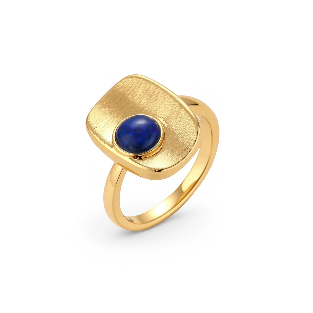 Adjustable gold-plated ring with textured square setting featuring a round blue lapis lazuli stone on cream background.