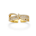 Close-up of gold-plated adjustable ring with crossing bands and sparkling zirconia stones on white background.